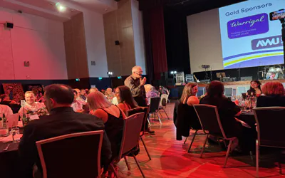 Elegant gala dinner entertainment setup with professional stage lighting